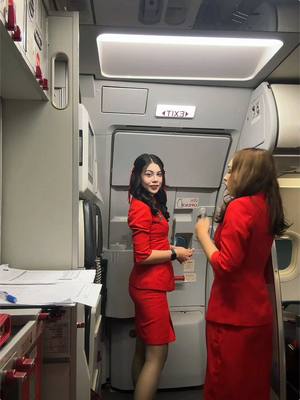 A post by @malytaheng on TikTok caption: Flying during Lunar New Year 🧧 ✨ @yvasierra444 #cambodia #khmer #fyp #AirAsia #airasiacabincrew #cabincrew #AirAsiaCambodia 