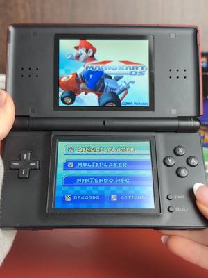 A post by @dkoldies on TikTok caption: What color would you get your DS lite? 🤔 #dkoldies #retrogamestore #handhelds #classsicgames #mariokart #DSLITE