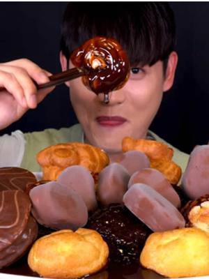 A post by @bonggil.eating.show on TikTok caption: Profiteroles Cream Bread With Chocolate MukBang! #asmr #asmrvideo #mukbang #bonggil #mukbangbonggil #asmrsegments #food #asmrfood #foodblogger #koreanfood #foodchallenge #eatwithbonggil #tiktokfood #foodvideo #foryou #fyp #foryoupage #fypシ゚viral #explore #yummy 