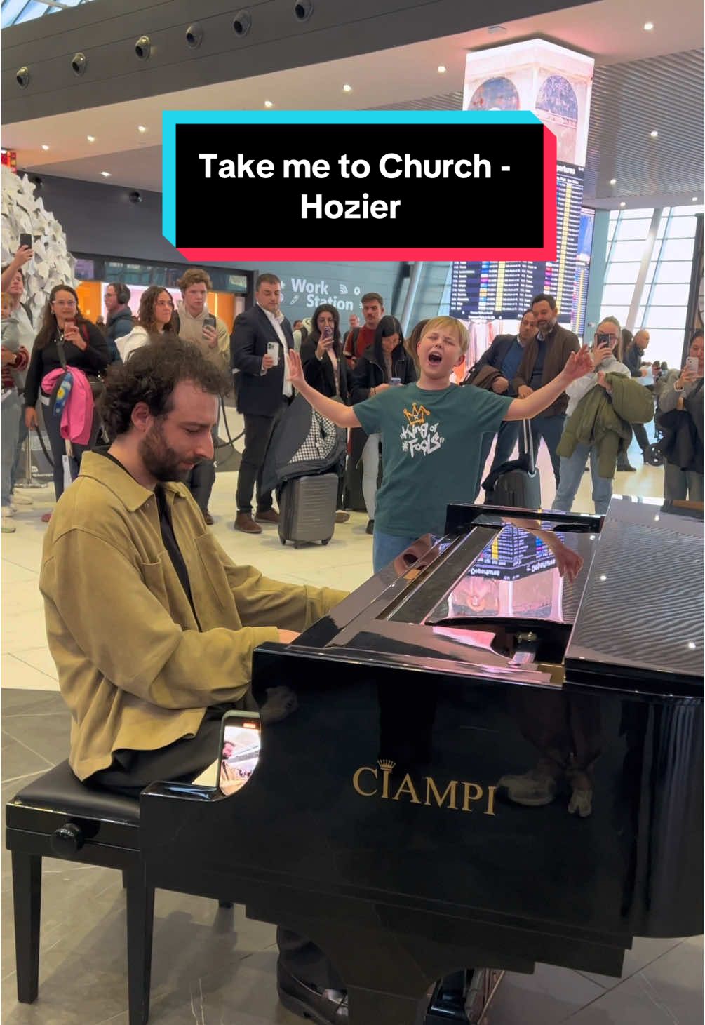 A post by @juliencohen_piano on TikTok caption: This little boy asked me to play Take Me To Church, but when he started singing, it was just incredible!! The whole airport couldn’t believe it 🤯😍 With the amazing @BJARNE_OFFICIAL in @Rome Airports 