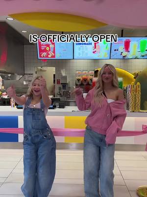 A post by @notenoughnelsonsofficial on TikTok caption: We’re Officially Open!!! ❤️💛💙🩷 #notenoughnelsons #hotdogonastick #nenfam @PaisLee Nelson @PaisLee and PresLee 