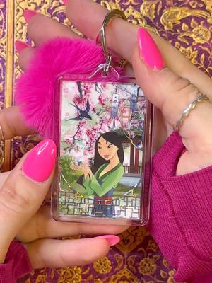 A post by @the_ripley_journals on TikTok caption: Mulan keychain 🌸 Let me know what I should do next!! PET tape is from @Shiimmer, see link in my bio ✨ #scrapbook #scrapbooking #junkjournal #junkjournaling #scrapbookasmr #scrapbookingideas #scrapbookwithme #asmrjournal #junkjournals #junkjournalwithme #junkjournalideas 