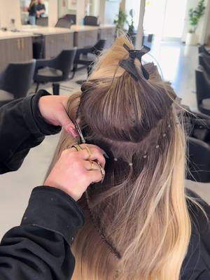 A post by @hairby_savannahbrooks on TikTok caption: Infinity weft removal, and chatting about baby boy with one of my fav clients! 💙🥹 #sandiego #sandiegohairstylist #foryoupage #blondemoment #champagneblonde #bellamihairpro #infinityweft 