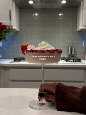 A post by @lexijxhnson on TikTok caption: Valentine’s Day Cocktails pt. 2: I guess we can call this a strawberries & cream martini? Chile Idk but this one’s for my dessert drink lovers.  I’m a dirty martini/ Bloody Mary kinda girl so for me to drink two of these says a lot! 2 oz vodka  2 oz Bailey’s strawberries & cream  2 oz milk (optional) 2.5 oz strawberry purée   *Shake dry, then add ice and shake again for like 15 seconds* if you want your thicker, you could add some vanilla ice cream & blend it For the purée: 1/2 cup water 1/4 cup sugar  1 cup strawberries Bring to boil until the sugar is dissolved, muddle the strawberries, and strain 