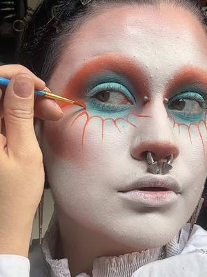 A post by @motherof.hades on TikTok caption: ORANGEEEE (and aqua)  #goth #gothmakeup #gothmodel #gothsofinstagram     #gothsubculture #motherofhades #weirdmakeup #experimentalmakeup #colourfulmakeup #abracadabra #ladygaga  @𝔇𝔯𝔬𝔭𝔇𝔢𝔞𝔡𝔊𝔬𝔯𝔤𝔢𝔬𝔲 @NYX Professional Makeup @Makeup A Murder, INC. @Black Moon Cosmetics @Mehron Makeup 