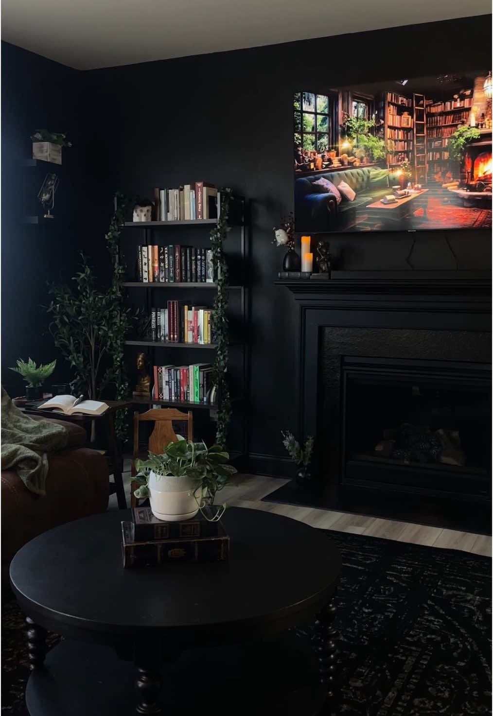 A post by @kcallanott on TikTok caption: my favorite place 🖤 #homedecor #homeinterior #blackwalls #booklover #bookworm #gothichome #darkacademia #gothicdecor #darkaesthetic #readersoftiktok #cozyathome #darkinterior 