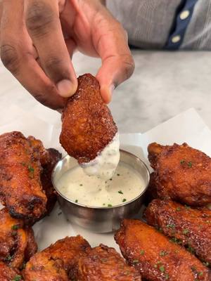 A post by @emmanuelduverneau on TikTok caption: BBQ Chicken Wings Recipe: 2 lb chicken wings, separated  2 tsp Liquid smoke  2 Tbsp yellow mustard  1 tsp paprika  1 tsp onion powder  1 tsp garlic powder  2 tsp kosher salt or Lawry’s Seasoned Salt  -Preheat oven to 400°F. -Pat wings dry with a paper towel and season with all ingredients. Mix until well combined.  -Dry batter 1 cup flour  1 cup corn starch  2 tsp salt  1 tsp garlic powder  1 tsp paprika  -Add all ingredients to a bowl and whisk until well combined. Add the chicken and toss, making sure it’s well coated. I like to also press the flour into the chicken. Once coated, gently shake off excess flour and place on a baking sheet. Let sit for about 5-10 minutes.  -BBQ Sauce  3/4 cup BBQ sauce  3 Tbsp honey  3Tbsp melted butter  -Mix all ingredients together in a bowl until sauce is smooth.  Frying: 7 cups canola oil -Heat oil to 350°F to 360°F. -Deep fry the wings in batches for about 8-10 minutes, until golden brown. I like to do drumsticks and wings separately so they cook evenly. Check the oil occasionally with an instant read thermometer to make sure it’s staying around 350°F to 360°F. Adjust heat when needed.  -Remove wings and set on a wire rack to drain.  -Once all wings are done, Brush BBQ sauce on all sides. Bake in a preheated oven at 400°F for 8-10 minutes until the sauce is baked on.  -Serve with your desired sauce and enjoy! #chicken #EasyRecipe #foodtiktok 