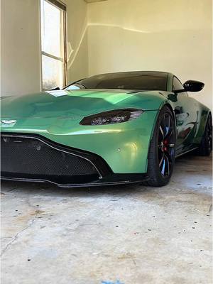 A post by @thewrapdaddy on TikTok caption: Patiently waiting.  It’s almost car season. Blow off that dust. Is your car ready?  #astonmartin #vantage #wrapped #wrappedcars #colorppf #armrstinggreen #carseason #2025 #prep #showtime #spring #car #exoticcars #supercar #dreamcar 