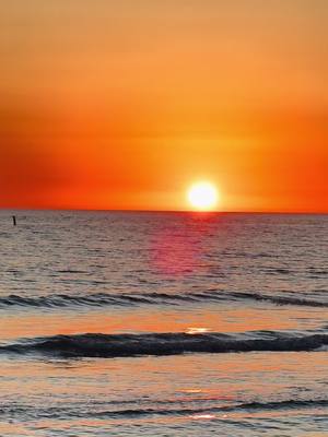 A post by @alliecheyswrld on TikTok caption: Best sunset of the year so far. Proof that stopping by a random beach on the trip home is always the move. Imagine missing this bc you wanted to get home quicker 🌅🌗 #roadtrip #traveltok #siestakey #sunset 