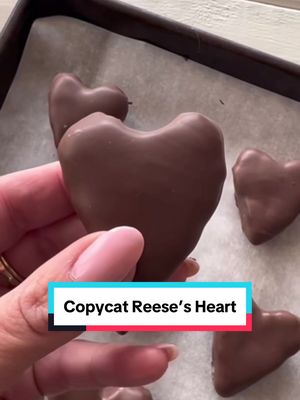 A post by @poshinprogress on TikTok caption: Love Reese’s Hearts? 🍫💖 Make your own version at home with this simple recipe! Head over to poshinprogress.com for the complete recipe to create these delicious chocolate-covered peanut butter hearts!  #CopycatRecipe ##copycatreeses #ValentinesDayTreats #ChocolatePeanutButter