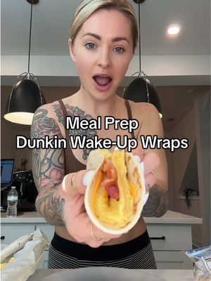 A post by @trainwithshay on TikTok caption: Low Calorie/High Protein Meal Prep Dunkin Wake-Up Wraps 🍳🧀🥓 Recipe makes 8 wraps Macros per wrap: 145 cals, 14P, 14C, 6F Ingredients: 8 La Banderita Carb Counter flour tortillas (the small 40 calorie ones) 8 Velveeta cheese slices 8 slices Black Label microwave ready bacon 368 grams (1 1/2 cups) egg beaters  112 grams (1/2 cup) fat free cottage cheese dash salt dash pepper dash garlic powder Directions: Preheat your oven to 400 degrees F.  Blend 112 grams (1/2 cup) fat free cottage cheese with ~20 grams water in a blender.  In a bowl, mix 368 grams ( 1 1/2 cups) egg beaters, the blended cottage cheese, dash of salt, dash of pepper, and dash of garlic powder. Line a 14x10 baking pan with parchment paper, and pour in the egg mixture. Bake for 8-10 minutes until eggs are fully cooked. Microwave the bacon according to the directions on the box.  Cut the eggs into 8 even squares once they are finished baking.  Add 1 slice cheese on top of each tortilla, then add one of the egg squares, followed by one slice of bacon.  *If you want to eat immediately, I recommend heating the tortilla in a pan with the cheese on top to melt it a bit before adding the egg.  *If you are meal prepping the wraps, you can either microwave or air fry them  to reheat them. Microwaving will make the wrap soft and air frying will make it more crispy. My cookbook is out now! www.trainwithshay.com/cookbook or 🔗 in byoooo for purchase