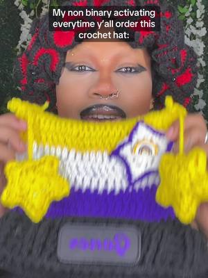 A post by @megagonefree on TikTok caption: My crochet cat ear beanies are BACK!! I hand make them all myself :D🧶✨ Get yours while supplies last <3 #handmade #merch #lgbt #enby #nonbinary 