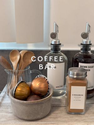 A post by @homewithhellen on TikTok caption: My new coffee corner @Nespresso  ☕️✨ Shop items linked on my LTK.  #coffeebar #coffeebarideas #athomecoffee  #coffee #coffeetok #cafe #nespresso #nespressovertuo #nespressovertouplus #homedecor #neutralhome #neutraleasthetic 