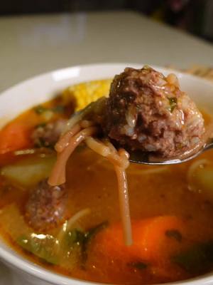 A post by @pizcitadesal on TikTok caption: Albóndigas con Fideo #albondigas #fideo #mexicanrecipe  Ingredients: 1 ½ lbs ground beef (80/20) 1 tbsp salt (for meatballs) ½ tsp garlic powder ½ tsp onion powder ¼ cup white rice 15 mint leaves, finely chopped 1 egg 2 tbsp oil (for searing meatballs) 4 tomatoes ¼ onion 2 garlic cloves 1 serrano chile 1 tbsp salt (for sauce) ½ cup water (for blending sauce) 8 cups water (for cooking) 2 potatoes, diced 2 carrots, diced 2 ears of corn, cut into smaller pieces 1 cup cilantro, chopped 2 tsp consomé de pollo