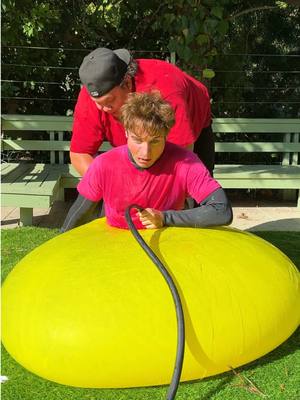 A post by @topperguild on TikTok caption: 100 BathBombs vs Giant Water Balloon 😱