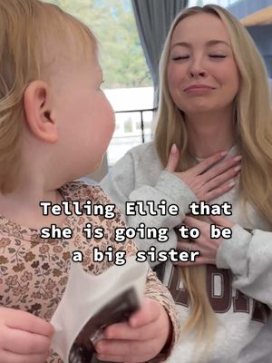 A post by @kayandtayofficial on TikTok caption: Awww when Ellie hugged them！🥹❤️ backstory ::: Kay is pregnant and so soon Ellie will go from the baby sister, to the big sister! 😭 We hadn’t told her yet, so we decided that we would show her the first pictures of her little brother/sister! ❤️ Kay came up while Ellie and I were playing, and showed her the ultrasound! Ellie didn’t really know what to do with it, and so she did what she always does. She said “whatzaa” which probably means, “omg yay! There’s my baby brother/sister” 😂 We are so excited for Ellie to have a little sibling to play with and protect! 🥹 It will be so fun watching them both experience their toddler years together! We are lucky that we also have Kinsley to help teach them! ❤️ #kayandtayofficial #couples #relationships #pregnant #postpartum 