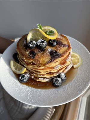 A post by @emmanuelduverneau on TikTok caption: Lemon Blueberry Ricotta Pancakes: Recipe: 6-8 oz blueberries  1/2 cup ricotta maple syrup powdered sugar  Dry batter: 2 1/2 cups flour  1 tsp baking powder 1 tsp baking soda  3 Tbsp sugar  2 tsp kosher salt  -Add all ingredients in a large bowl and whisk together.  Wet batter: 2 1/2 cups buttermilk  1 stick unsalted butter, melted 2 egg yolks, reserve egg whites for later  2 tsp vanilla extract  1 lemon zested juice from 1/2 a lemon -Add all ingredients to a large bowl and whisk together.  -Add wet ingredients to dry Ingredients and gently mix until just combined. Don’t over mix. Add egg whites and mix just until combined. Mix in blueberries and ricotta. Let mixture sit for 15-20 minutes before cooking. Cook until golden brown on both sides. Top with maple syrup and powdered sugar and enjoy! #pancakes #foodtiktok #breakfast #EasyRecipe 