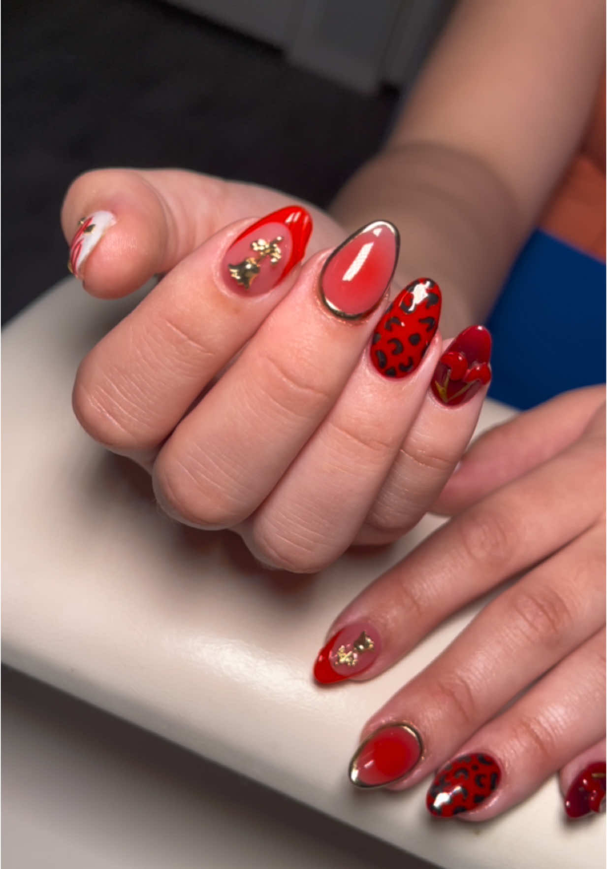 A post by @_nailzbymariah_ on TikTok caption: #nailzbymariah #goodyearnailtech #aznails #athomenailtech #fyp #explorepage #vbeautypure #beetlesgelpolish #kupatopcoat #nailsandblinks #nailsandblinks #rednals #valentinesdaynails #frenchtipnails #auranails #cheetahnails #3dcherrynails 