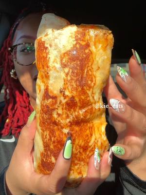 A post by @kie_eats on TikTok caption: Okayyyy @tacobell grilled cheese burrito this was a giant burrito #asmr #mukbang #burrito #tacobell #grilledcheeseburrito Taco Bell grilled cheese burrito mukbang