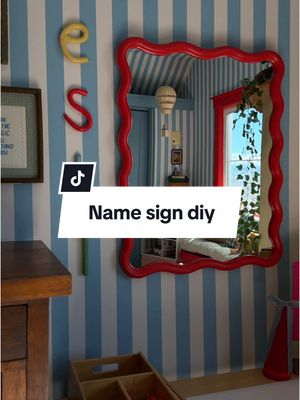 A post by @kyliekatich on TikTok caption: NO TOOLS NEEDED— CLAY NAME DIY- playful, whimsical, affordable and EASY!!!!!! #diycraft #clayarts #ovenbakeclay #playroominspo #nameclay 