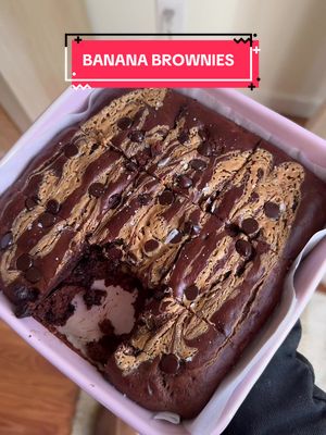 A post by @caileeeats on TikTok caption: Banana Brownies!! 🍌✨🤤 full recipe below 👇🏻  Original recipe is from @theovenlight (I added protein powder & used peanut butter instead of almond butter!)  3 ripe bananas smashed  1/2 cup clean simple eats protein powder (i used bananas foster flavor!)  ½ cup Kirkland peanut butter 3 tablespoons pure maple syrup  1 teaspoon pure vanilla extract  2 large eggs  ½ cup unsweetened cocoa powder  ½ teaspoon baking soda 1 cup chocolate chips divided  A pinch of sea salt Instructions  1. Preheat oven to 350 degrees.  2. Line an 8x8 baking dish with parchment paper and set aside.  3. In a large mixing bowl, mash ripe bananas with a fork. Add peanut butter, maple syrup, vanilla and eggs. Mix well until smooth. 4.  Add unsweetened cocoa powder, protein powder, baking soda, and a pinch of salt to the wet ingredients. Mix until just combined.  5. Gently fold ⅔ cup chocolate chips into the batter  6. Swirl a few spoonfuls of peanut butter (optional) 7. Add the brownie batter to prepared baking dish, then add the rest of the chocolate chips on top.  8.  Bake for 30-40 minutes, or until fully cooked.  #healthydessert #bananabrownies #healthydessertidea 