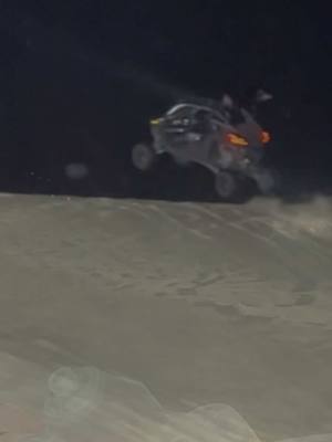 A post by @tommymurf on TikTok caption: Little night ride at #dumontdunes with an easy nighttime transfer over comp…. #tommymurf #rzr #canam 