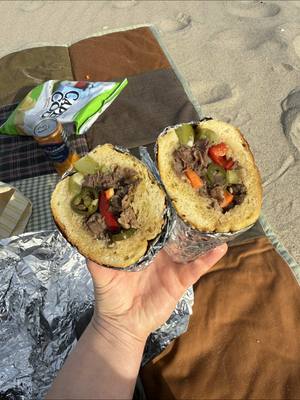 A post by @haileecatalano on TikTok caption: the perfect beach sandwich for a warm day in February ☀️  the Chicago style braised beef sandwich from my cookbook!