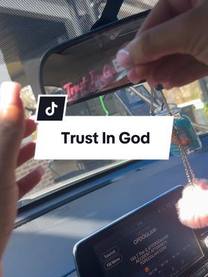 A post by @beyondloved on TikTok caption: Trust In God car decor, do the right thing and click the link below. #car #trustingod #god #cardecor #pink #reviewmirror 