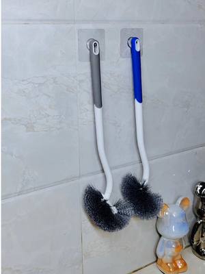 A post by @nlhuk01 on TikTok caption: This long-handled toilet brush has an elbow design and very hard bristles, which can easily clean the toilet. It is convenient, quick and easy to use #Bathroom#ToiletBrush