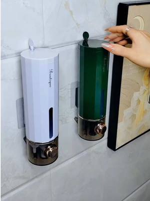 A post by @nlhuk01 on TikTok caption: Shower gel, shampoo, and hand soap can all be put in this soap dispenser and stored on the wall. There will no longer be a mess on the countertop #soapdispenser #bathroom