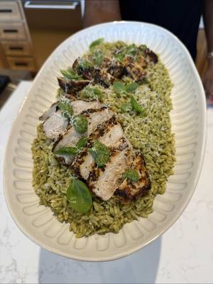 A post by @emmanuelduverneau on TikTok caption: I’m at CrateKitchen cooking up a healthy weeknight meal that won’t sacrifice on flavor-Pesto Orzo with Chicken. Get the recipe at @crateandbarrel’s bio link.          Recipe: Chicken: Juice from half a lemon 1 teaspoon salt 1 teaspoon black pepper 1 tablespoon dried parsley 1 tablespoon dried oregano 1 tablespoon garlic powder 1 tablespoon dried thyme 2 chicken breasts 2 tablespoons olive oil 2 tablespoons butter - Preheat the oven to 350°F - Add all herbs, seasonings and lemon juice to a medium bowl. Stir to combine. Add chicken and coat with seasonings. Cover and let sit for 15 minutes to marinate. - Add the olive oil to a frying pan over medium-high heat. Sear chicken on one side for 4–5 minutes. Flip, add the butter and baste the chicken for 2–3 minutes. Remove pan from heat and add to the preheated oven. Bake for 15 minutes, or until internal temperature reaches 165°F. Pesto: ¼ cup pine nuts 1¼ cup packed basil leaves 5 garlic cloves ⅓ cup Parmesan cheese, grated 2 tablespoons lemon juice a pinch of salt 3 tablespoons olive oil - Lightly toast pine nuts in a small frying pan over medium-low heat. - Add all the pesto ingredients to a food processor and process until smooth. Set aside. Pasta: 1 (16 ounces) box orzo 1 teaspoon salt - Add water to a saucepan. Bring to a boil, season with salt and add orzo. Cook until al dente and drain To Serve: - Toss pasta with pesto, add chicken and enjoy!