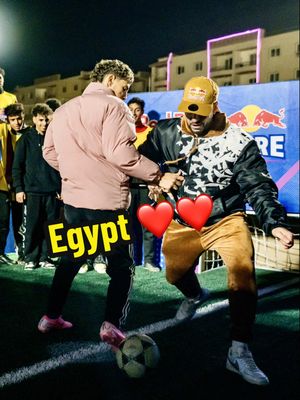 A post by @seanfreestyle on TikTok caption: Which country dominates street football? 🌍🔥 Drop your flag below! 👇🏾👇🏽👇🏼” Egypt brought the heat at Red Bull Four 2 Score! 🇪🇬⚽ But can another country top this? 👀 🔥 Atmosphere: 10/10 – Ismailia people were super engaged and brought insane energy! ⚔️ Level & Tournament: 7/10 – The competition was intense, but the semi-finals were pure drama! Emotions ran high, real passion from the players, and some heated battles on the pitch… but are they the best? 👀 💥 Sean vs Egypt: 6/10 – A hard challenge for me that time! Couldn’t shine that easy, but wish I had faced more fair play ballers. 📍 Location: 7/10 – First time in Ismailia! The pitch was near a mosque, surrounded by cool buildings, but the artificial grass was too high and not the best quality. Think your country can do better? Tag your squad & prove it! 👇🔥 #RedBullFour2Score #StreetFootball #urbanball 
