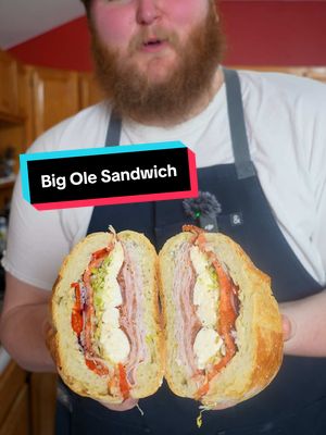 A post by @chefzealand on TikTok caption: An absolute behemoth of a sandwich ft. my dog 😂  Ingredients:  Genoa Salami  Mortadella  Coppa Picante  Porchetta Cotta Fresh mozzarella  Tomatoes  Shredded lettuce  Thinly sliced red onion  Pickled cherry peppers  Salt and pepper  Oregano  Mayo  Olive oil  Red wine vinegar  #sandwich #coldcuts #italiansandwich #sub #subsandwiches #food #foodie #chef #recipe #fyp 