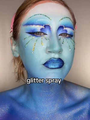 A post by @katiefarhood on TikTok caption: I want my entire body covered in this 24/7 tyvm #glitterspray #makeuptutorial #glittermakeup #rhinestonemakeup #editorialmakeup 