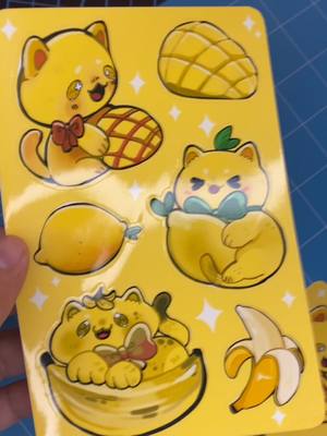 A post by @chynn2x on TikTok caption: day 4 of posting till I Open my etsy shop, I designed and created a new sticker sheet and all yellow fruit cats! ain't that so cuteeee <3 lowkey loving the asmr sounds of making stickers except for the sound of the silhouette #SmallBusiness #etsy #stickershop #sticker #stickersheet #stickersheets #asmr