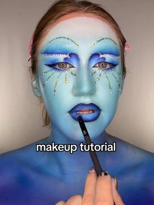 A post by @katiefarhood on TikTok caption: these looks from @Ellis_Atlantis were so beautiful I HAD to have them on my face 🩵💙 #makeuptutorial #editorialmakeup #makeupartist #sfxmakeup #glittermakeup #rhinestonemakeup 