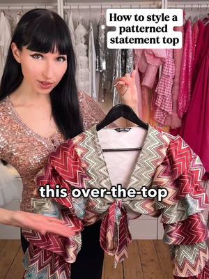 A post by @andreasfashiongalaxy on TikTok caption: How to style a statement ruffle top with bold patterns #letsgetdressed 