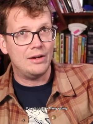 A post by @hankgreen1 on TikTok caption: We get to use words however we want!!  #pluto #space #askhank 