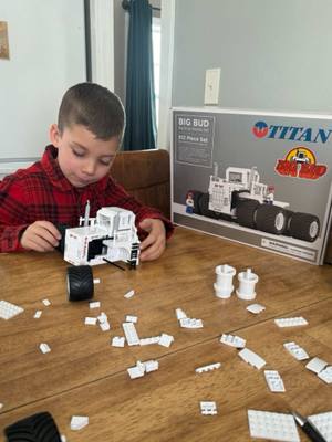 A post by @justajacksonthing on TikTok caption: Jackson enjoyed putting together this gift that the Williams Big Bud family sent him. Pretty cool build gets all the details of the #BigBud747 he’s going to display it in the new barn #bigbud #williamsbigbud #justajacksonthing #makefarmingfun #oldschool #tractor 