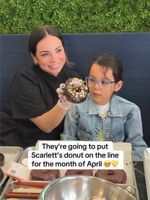 A post by @charlie on TikTok caption: A dream come true for Scarlett 🥹 Thank you @Alexandra Lourdes for your big heart ❤️ If you’re in Vegas, pls grab one of Scarlett’s donuts🎗️💛 #donut #donutshop #vegas #dreamscometrue #kindness #sainthonore 