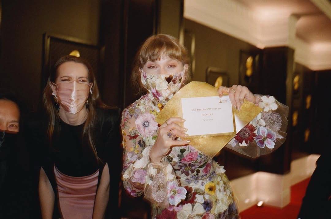 A post by @taylornation on TikTok caption: spinning in our highest heels, love, because it’s been four years since our folklorian fairy won Album Of The Year at the GRAMMYs 🧚🏻🩶🌿🌲