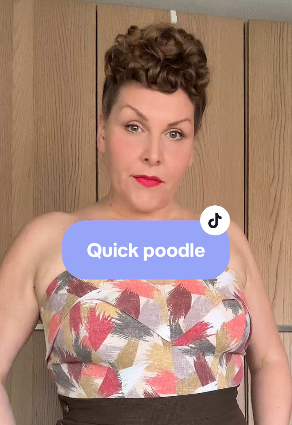 A post by @hollandschmeisje on TikTok caption: Quick poodle tutorial for those of you who don’t like the hairnets I usually use! And a little pink ootd. Have a fab weekend!  Lippy @Dafna Beauty Pinup Pink Elephant pins @Luxulite Bangles @Splendette Hairflowers PinupCurl and Elephant bag @wickerdarling #vintagehair #vintagepoodle #vintagestyle