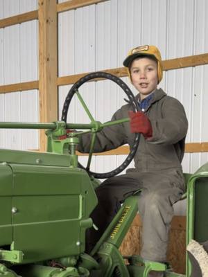 A post by @justajacksonthing on TikTok caption: Our local county auction a few weeks ago had a great selection of tractors - debate as always between Jackson and his Dad - #johndeere 4020 or 4320??#justajacksonthing #makefarmingfun #oldschool #tractor #auction #futurefarmer #dekalb 