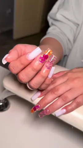 A post by @_nailzbymariah_ on TikTok caption: Spring nails are calling! 🌺🌸🌼 #nailzbymariah #goodyearnailtech #aznails #athomenailtech #fyp #explorepage #vbeautypure #beetlesgelpolish #kupatopcoat #nailsandblinks #milkywhite #springnails #flowernails #nailinspo  #nailinsperation #encapsulatednails 