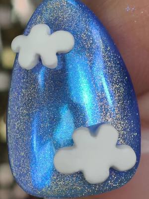 A post by @ilysmnails on TikTok caption: These fluffy clouds look great to sleep in! ☁️ Team 'Jennie' or Lisa? Ruby or Alter Ego? These Nails give a 'Jennie' vibe! Blue Cat Eye Polish with a layer of transparent Chrome 💅🏽 ilysmnails .com #nails #nailsart #satisfying #beautyhacks #asmr 