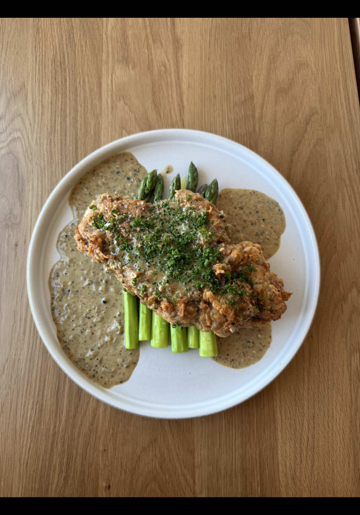 A post by @chuckischarles on TikTok caption: Chicken fried steak with au poivre gravy