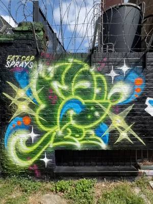 A post by @fatcapsprays on TikTok caption: Bright Neon Green Dino Monkey Street Art! #spraypaint #painting #fatcapsprays #art #satisfyingart