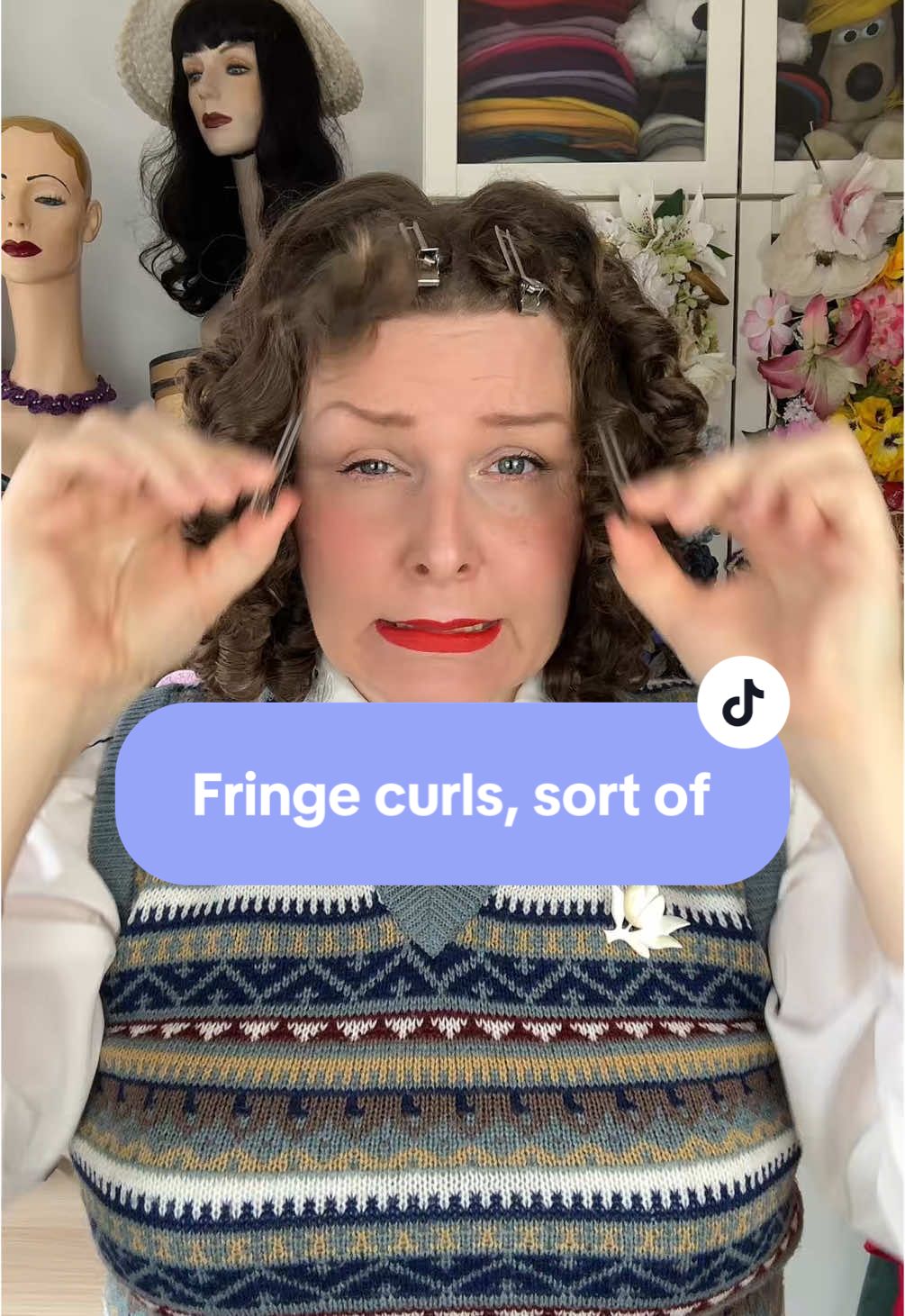 A post by @hollandschmeisje on TikTok caption: Cut myself a fringe, it might be a bit of a challenge to style it 😅 outfit all from lovely vintage shops & vinted except for house of foxy skirt and bait shoes. Lippy is Vintage Starlet by @Dafna Beauty Happy Friday!  #truevintage #vintagehair #vintagestyle 