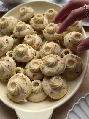 A post by @kookmutsjes on TikTok caption: CHOCOLATE SWIRL COOKIES #food #recipe #cookies #swirl #chocolate #eid #eidmubarak #fyp #foryoupage FOR MINI BUNDT COOKIES 300 g white chocolate COOKIE DOUGH 150 g unsalted butter 100 g powdered sugar 8 g vanilla sugar (1 tbsp) or 1 tsp vanilla extract 1 egg (medium) 200 g flour (all-purpose flour) 100 g cornstarch 3 g baking powder COATING 400 g white chocolate GARNISH pistachios rose petals EXTRAS white chocolate pistachio paste Total 60 cookies Instructions: Melt the white chocolate (300 g) using the double boiler (au bain-marie) method. Pour the melted chocolate into a piping bag. Take a silicone mold and fill the mini bundt shapes with the melted white chocolate. Place the mold in the refrigerator or freezer to allow the chocolate to harden completely. Put the softened butter, powdered sugar, and vanilla sugar in a deep bowl. Mix until combined. Add the egg and mix thoroughly. Add the flour, cornstarch, and baking powder. Knead until smooth. Dust your workspace with some flour and roll out the dough to a thickness of less than 1 cm. Use a cookie cutter to cut out the desired shapes. Place the cookies on a baking tray lined with parchment paper. Preheat the oven to 200 °C (400 °F). Bake the cookies for 10-12 minutes. Let them cool completely. Melt the white chocolate (400 g) using the double boiler method. Dip the top of the cooled cookies into the melted white chocolate and place them on a sheet of parchment paper. Decorate the cookies with a chocolate bundt cookies, chopped pistachios, and rose petals. Fill the hollow of the bundt cookies with white chocolate or pistachio paste. Let the chocolate set completely. TIPS: Melt the chocolate over low temperature using the double boiler method to prevent burning. Stir regularly and ensure no water comes into contact with the chocolate to avoid splitting. Make sure the bundt cookies are fully set before removing them from the mold. Avoid over-kneading the cookie dough to keep the cookies from becoming tough. Allow the cookies to cool completely before dipping them in the melted chocolate. Place them on parchment paper to prevent the chocolate from sticking during setting. Use a type of chocolate that you personally enjoy.