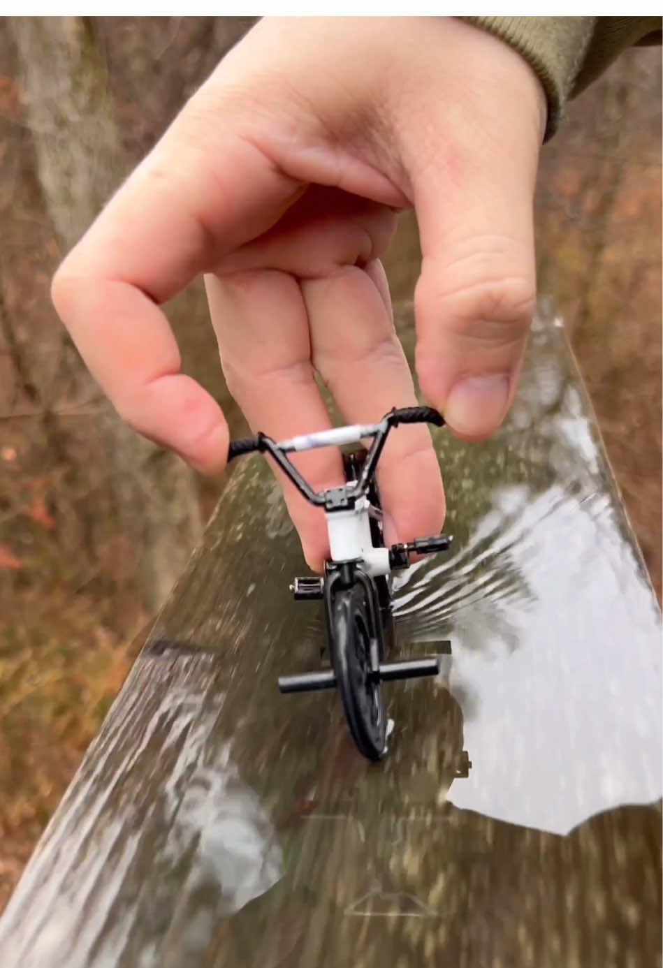 A post by @stonedboarder on TikTok caption: Satisfying 🌧️ #fingerbmx #bmx #techdeck #relaxing #bmxtricks #bmxlife #mini #fingerbike #chill #fyp 